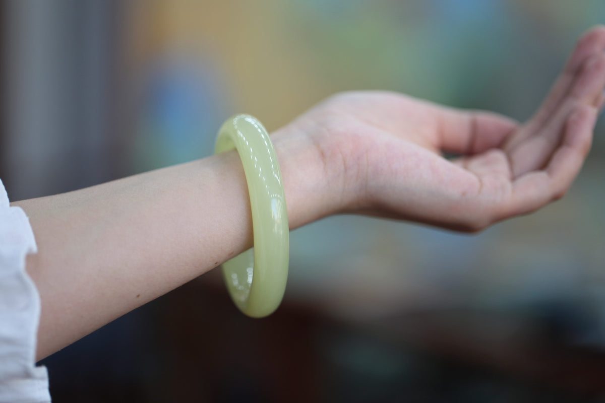 ATELIER 012 · Golden Green — nephrite jade round bangle, on the wrist
