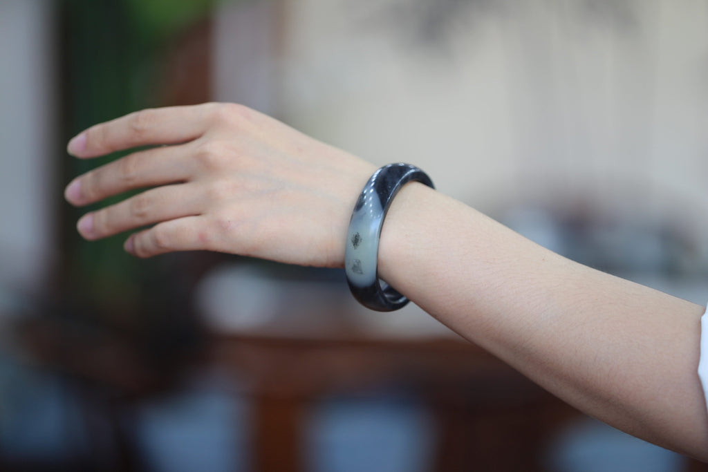 ATELIER 014 · Ink Wash — nephrite jade flat bangle, on the hand