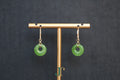 ATELIER 024 · Willow Green — nephrite jade earrings, on a display stand