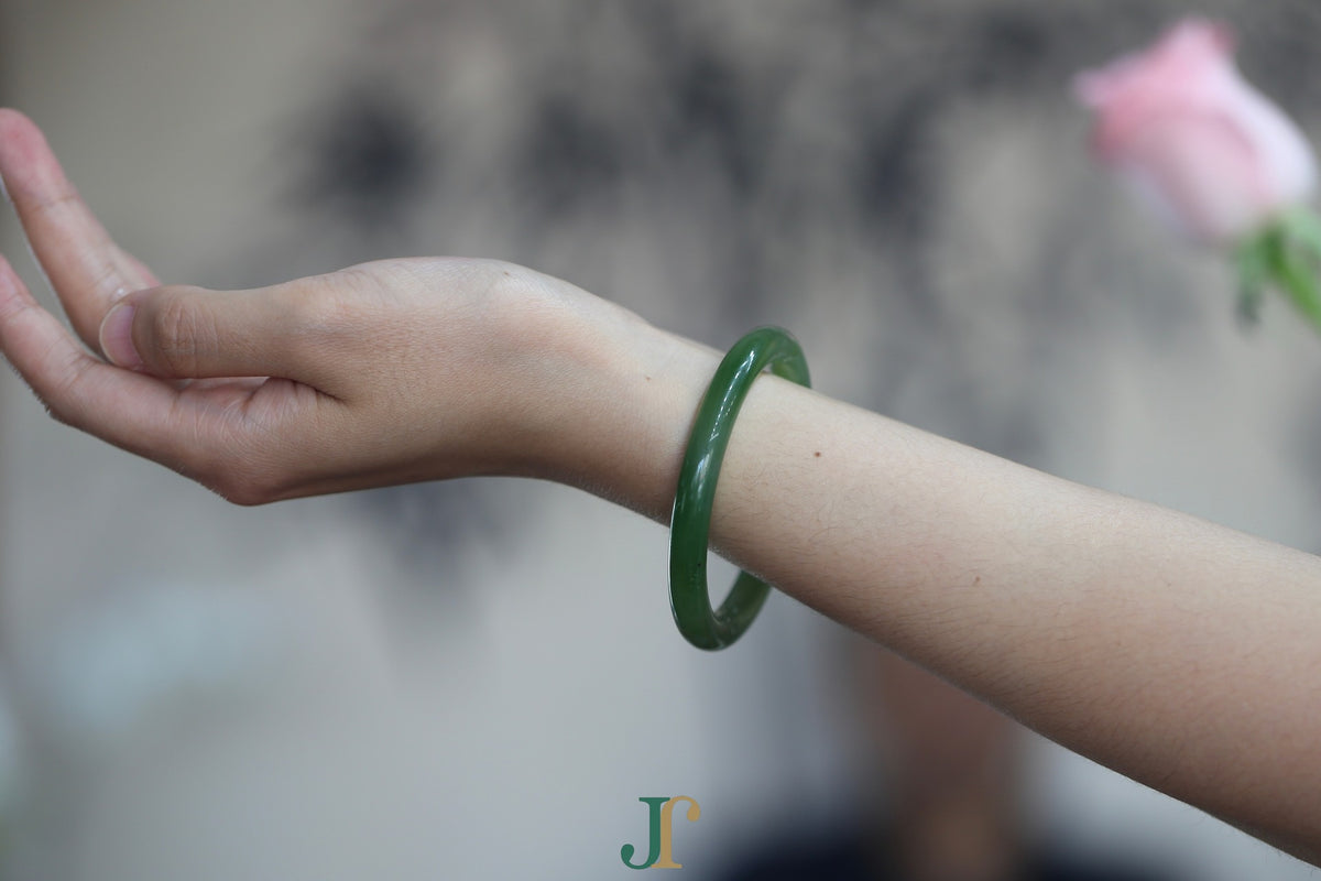 ATELIER 026 · Willow Green — nephrite jade round bangle, on the wrist