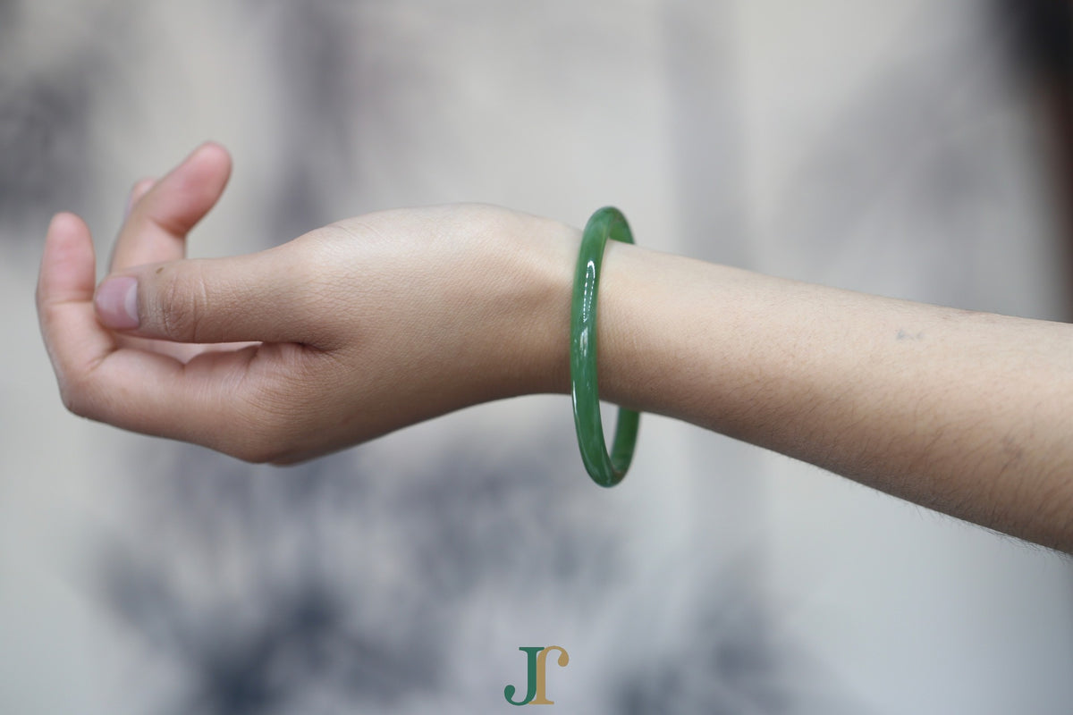 ATELIER 028 · Willow Green — nephrite jade round bangle, on the wrist