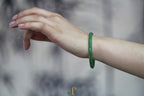 ATELIER 028 · Willow Green — nephrite jade round bangle, on the model