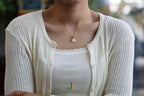 ATELIER 033 · Suet White — nephrite jade pendant, worn