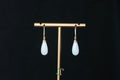 ATELIER 035 · Suet White — nephrite jade earrings, on a display stand