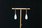 ATELIER 035 · Suet White — nephrite jade earrings, on a display stand