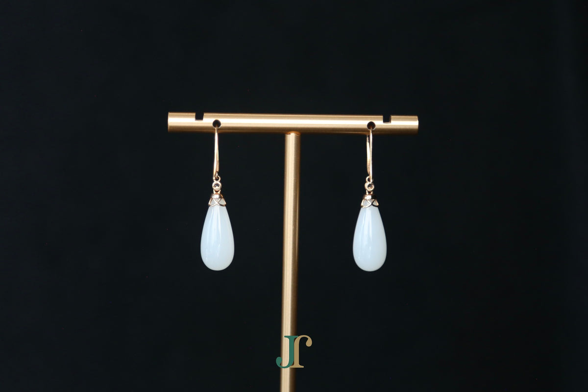 ATELIER 035 · Suet White — nephrite jade earrings, on a display stand