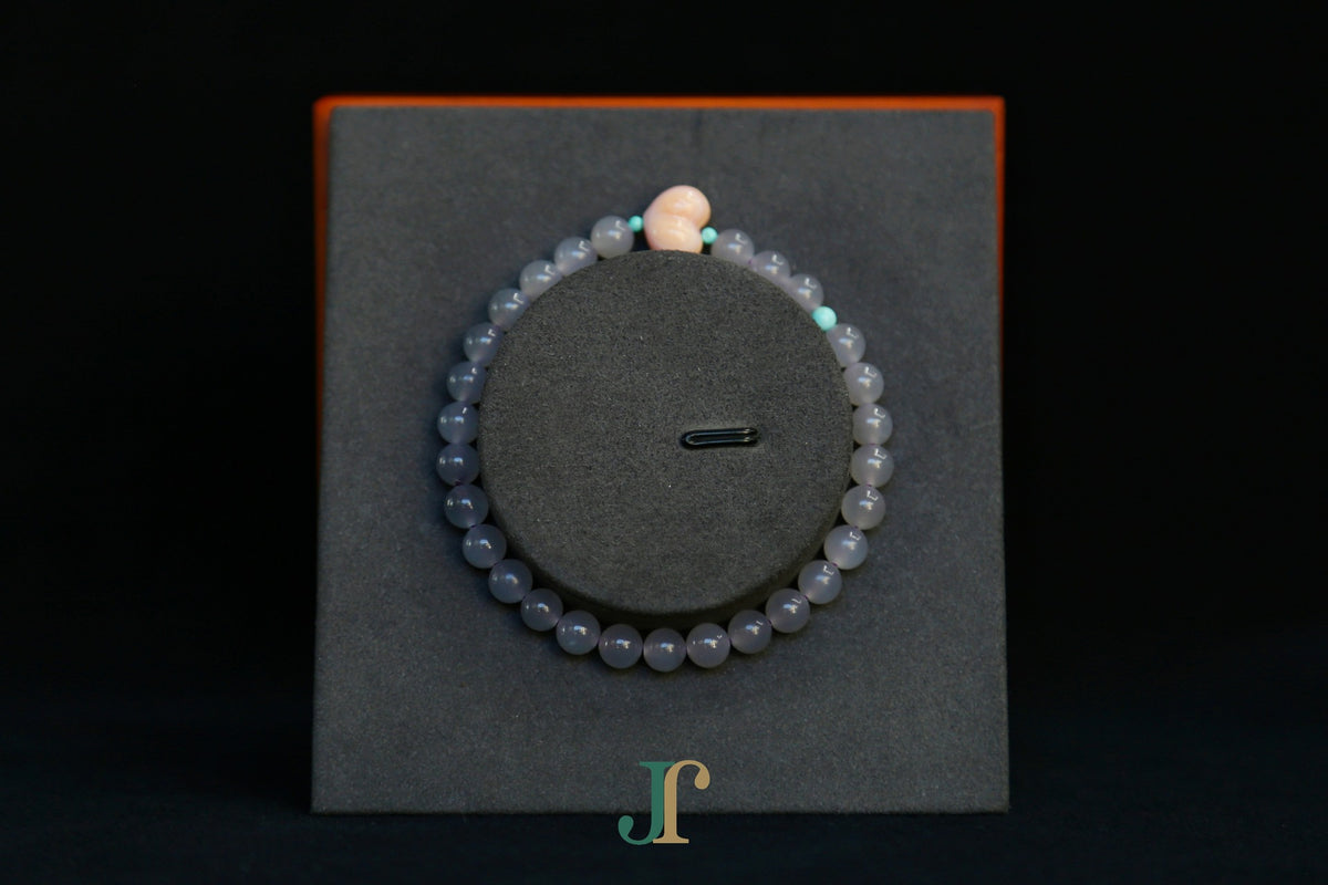 GAIA Earthy 6 Spiritual · Smoky Lilac · Heart — nephrite jade bead bracelet, on a display stand