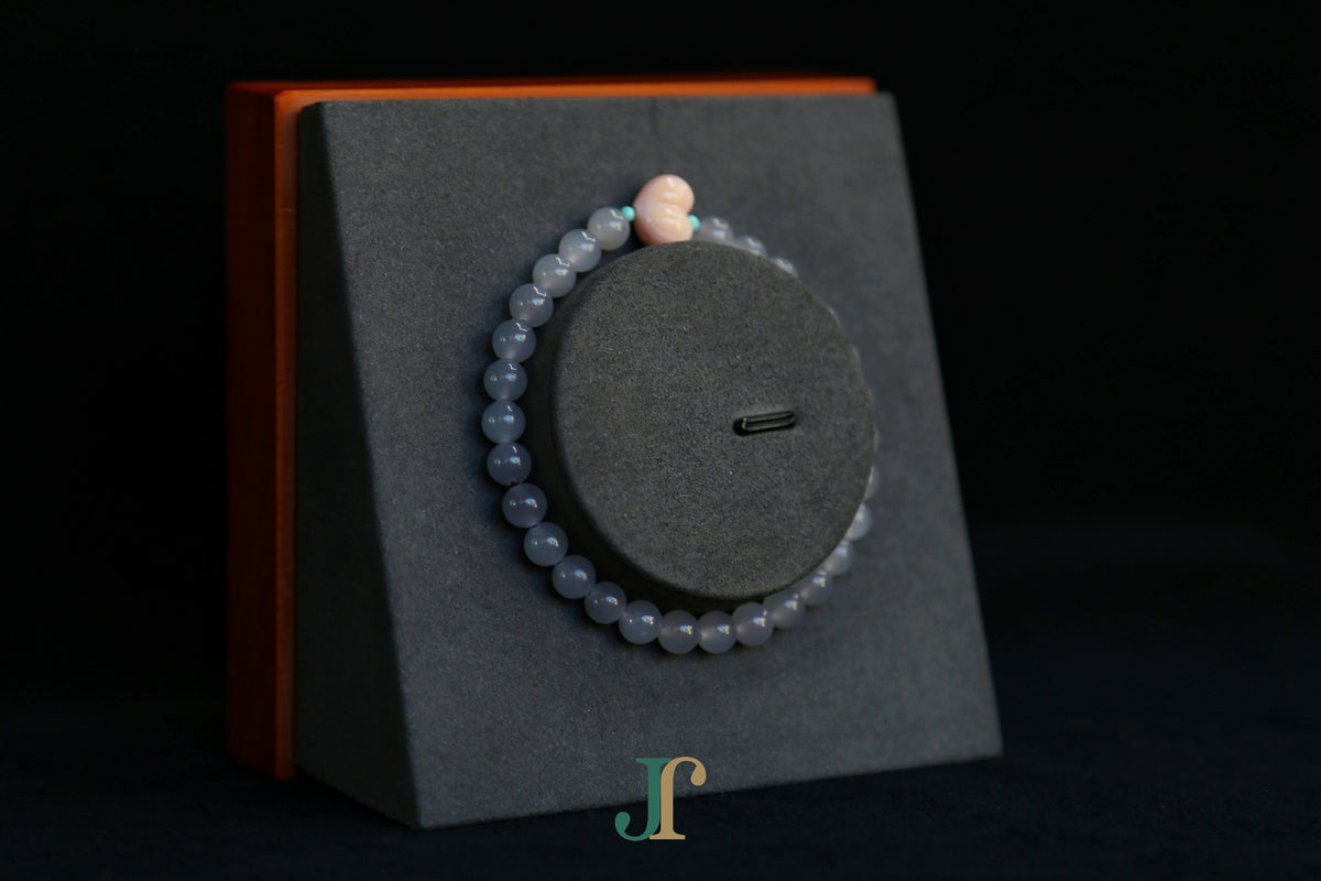 GAIA Earthy 6 Spiritual · Smoky Lilac · Heart — nephrite jade bead bracelet, on a display stand, second view