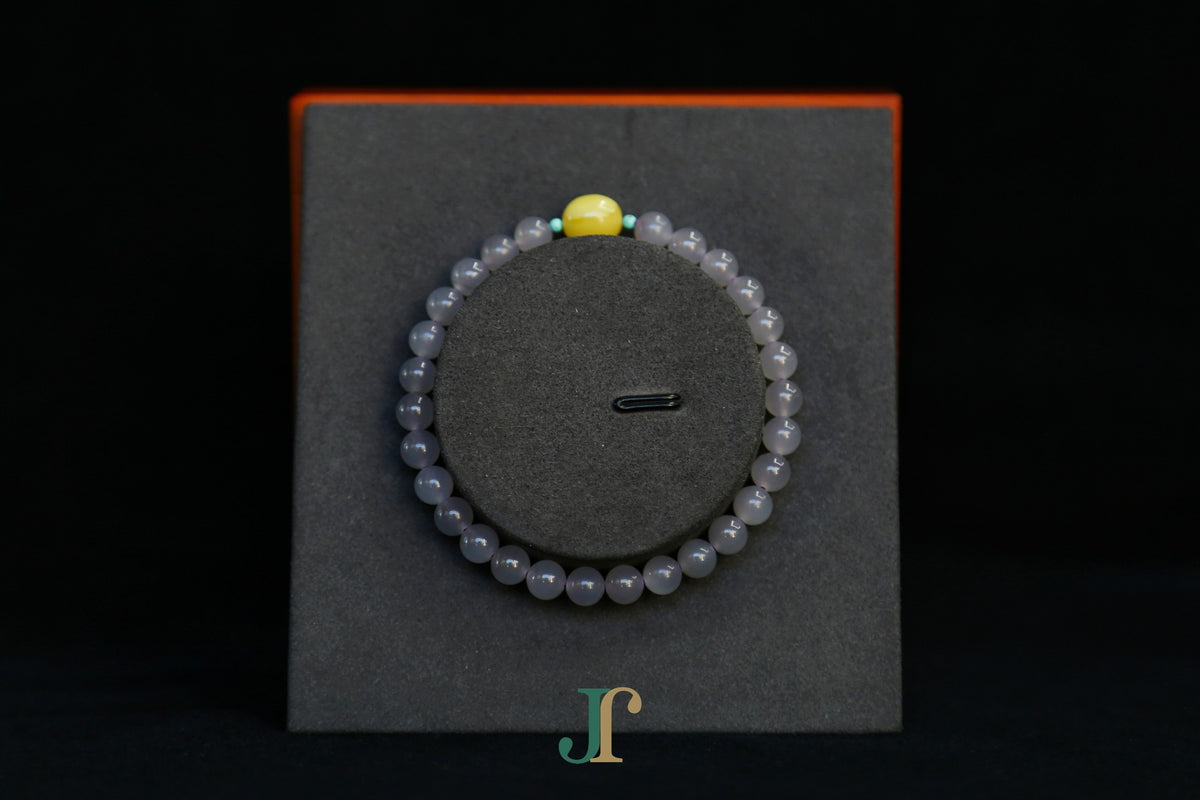 GAIA Earthy 6 Spiritual · Smoky Lilac · Oval — nephrite jade bead bracelet, on a display stand