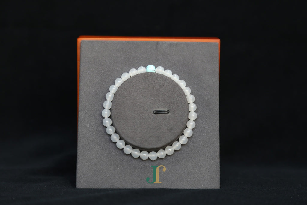 GAIA Earthy 6 Spiritual · Suet White · Turquoise — nephrite jade bead bracelet, on a display stand