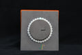 GAIA Earthy 6 Spiritual · Suet White · Turquoise — nephrite jade bead bracelet, on a display stand
