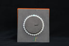 GAIA Earthy 6 Spiritual · Suet White · Turquoise — nephrite jade bead bracelet, on a display stand