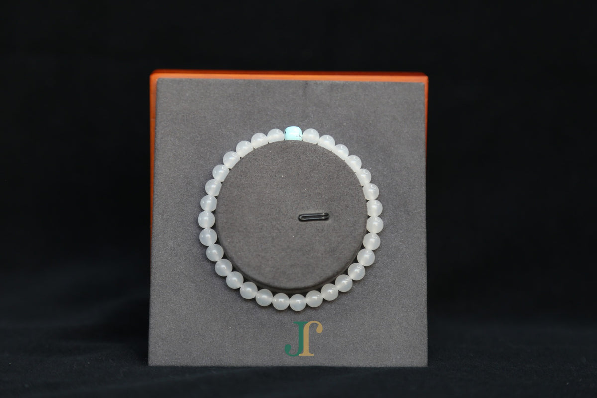 GAIA Earthy 6 Spiritual · Suet White · Turquoise — nephrite jade bead bracelet, on a display stand