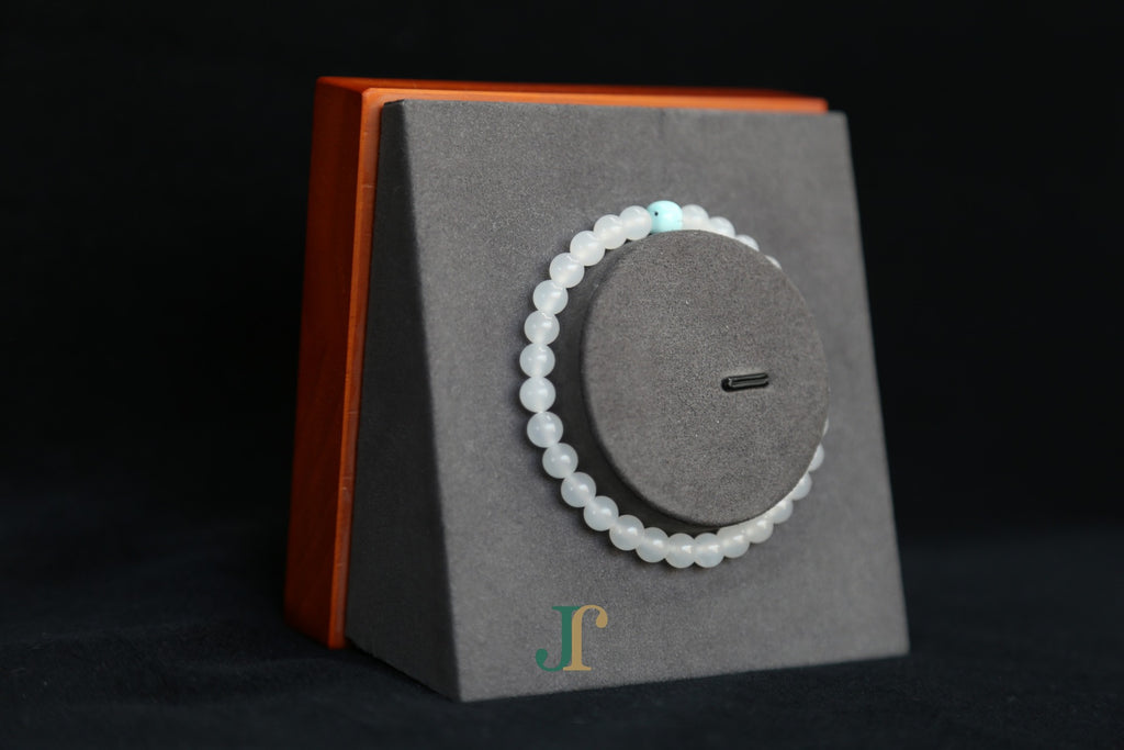 GAIA Earthy 6 Spiritual · Suet White · Turquoise — nephrite jade bead bracelet, on a display stand, side view