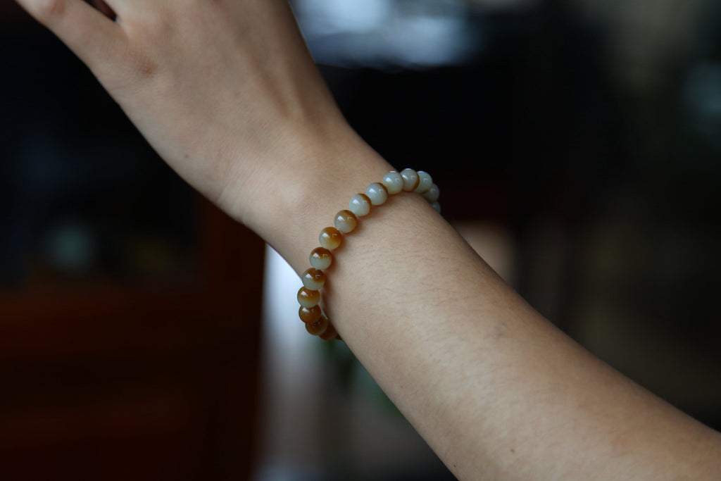 GAIA Earthy Honey Amber — natural nephrite jade bead bracelet, on the wrist