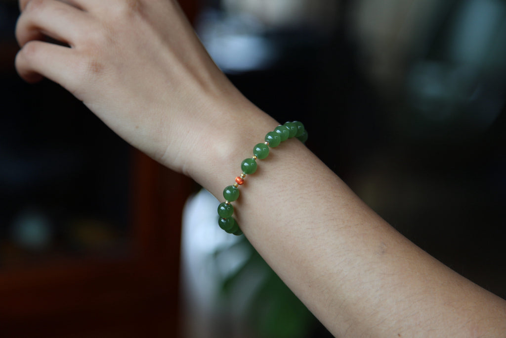 GAIA Earthy Red Bean — natural nephrite jade bead bracelet, on the wrist