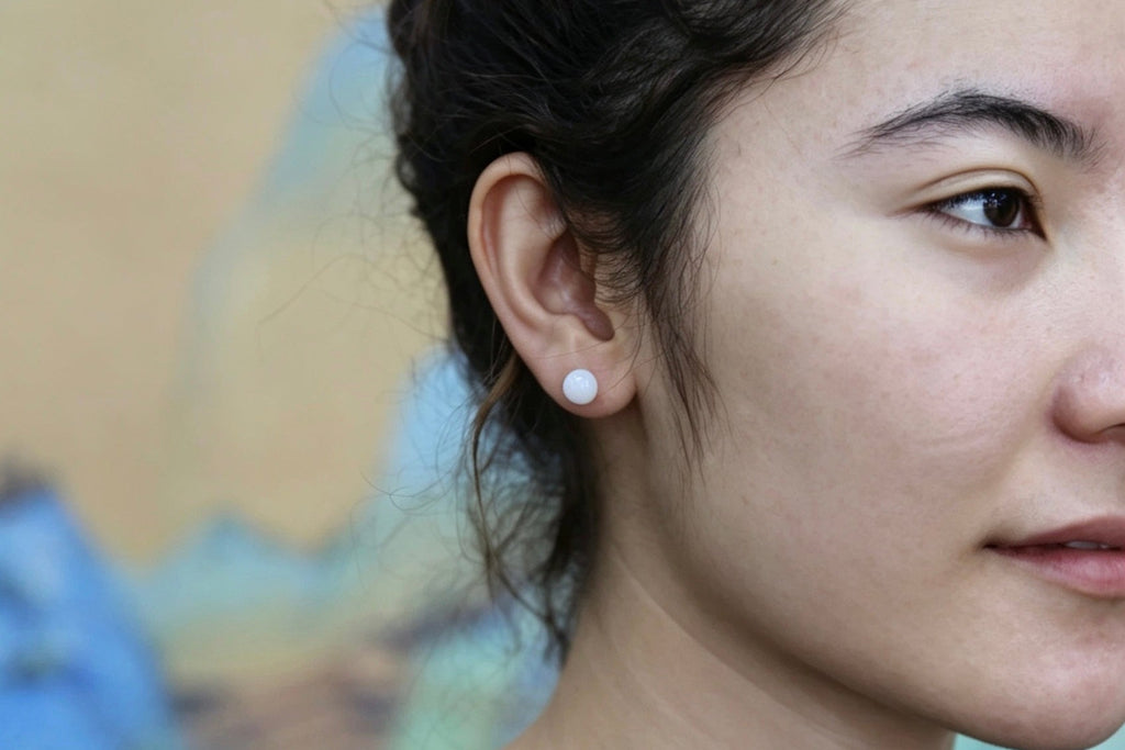 GAIA Luna 8 · Suet White — nephrite jade earrings, on the hand
