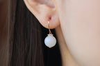 GAIA Luna 10 · Suet White — nephrite jade earrings, on the model, profile