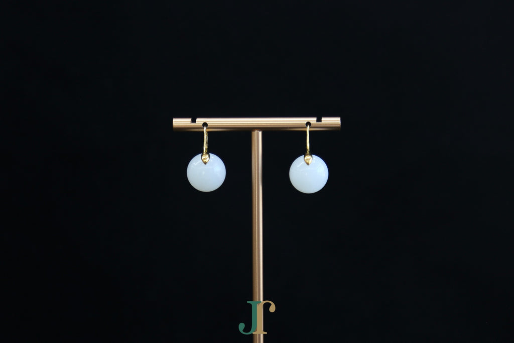 GAIA Luna 14 · Suet White — nephrite jade earrings, on a display stand