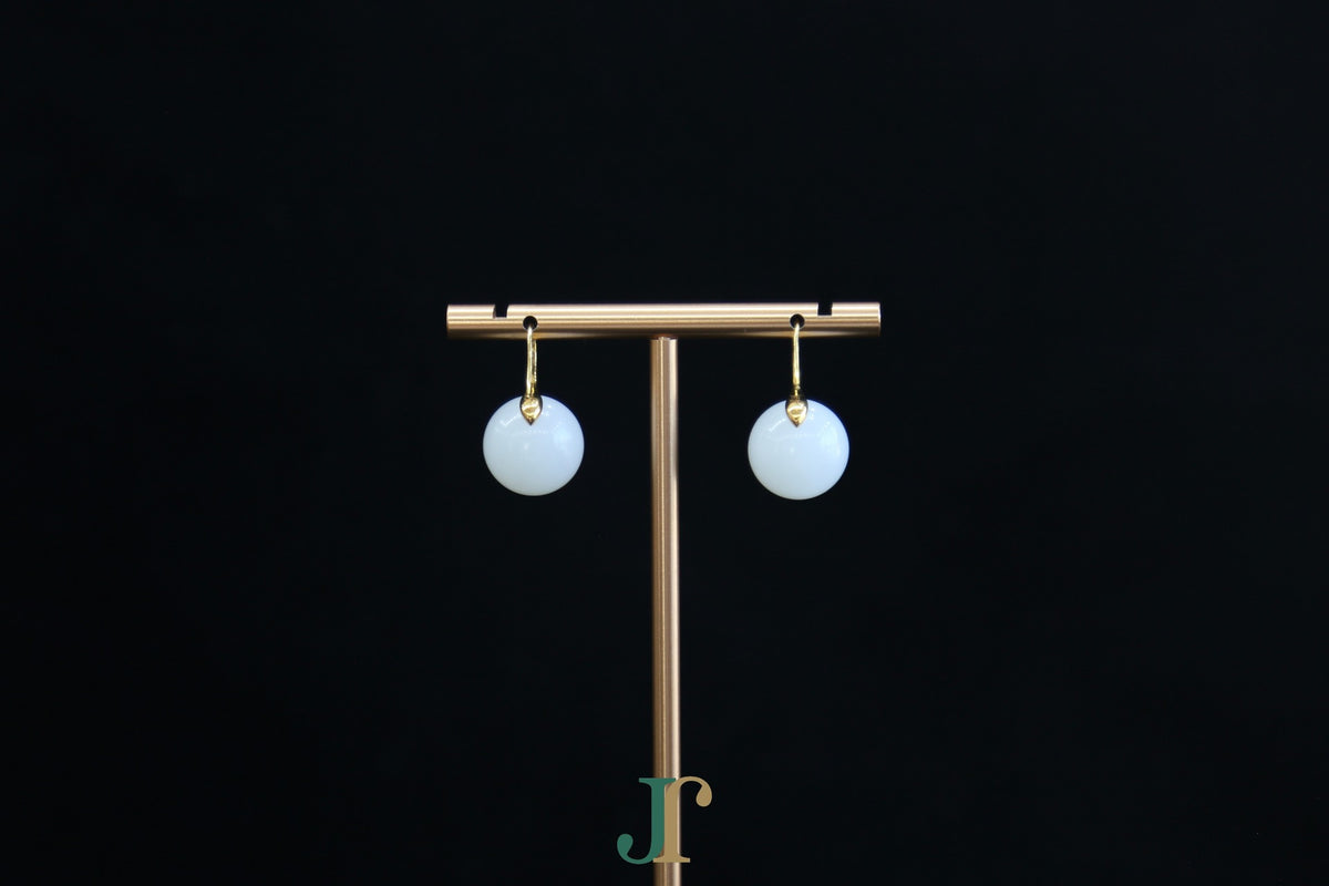 GAIA Luna 14 · Suet White — nephrite jade earrings, on a display stand