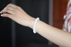 GAIA Earthy 10 · Suet White — nephrite jade bead bracelet, on the hand