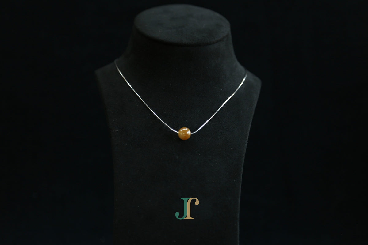 GAIA Pure 10 · Caramel — nephrite jade bead necklace, on a display bust