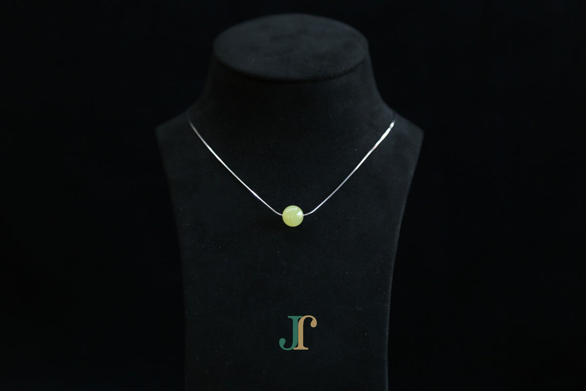 GAIA Pure 10 · Golden Green — nephrite jade bead necklace, on a display bust