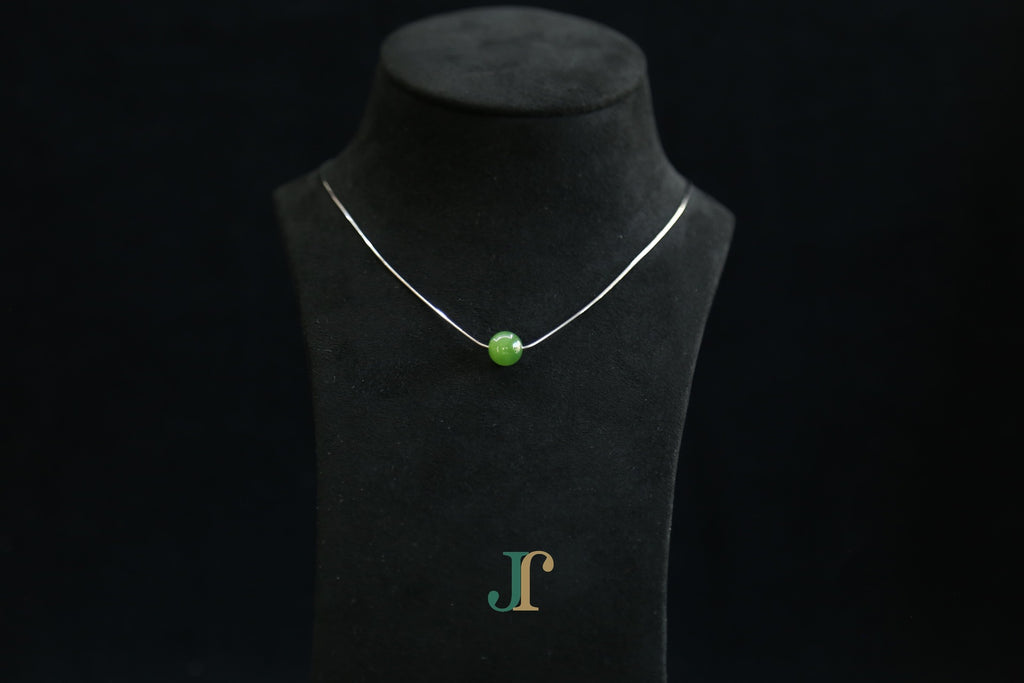 GAIA Pure 10 · Spinach Green — nephrite jade bead necklace, on a display bust