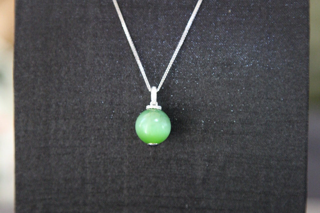 GAIA Serenity · Cat's Eye — nephrite jade pendant, on the model