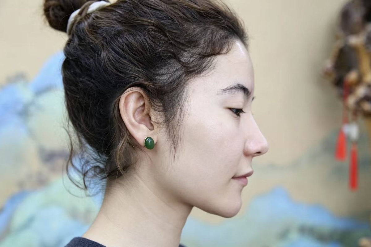 GALET 006 · Willow Green — nephrite jade earrings, on the hand