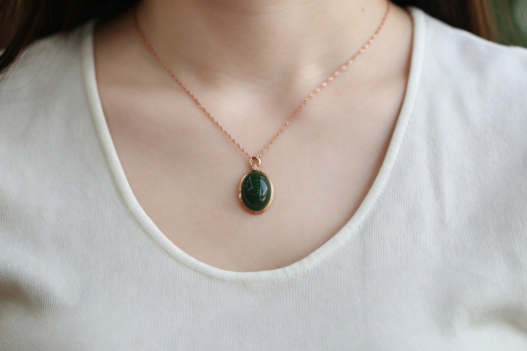 GALET 010 · Spinach Green — nephrite jade pendant, on the hand