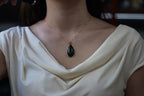GALET 011 · Spinach Green — nephrite jade pendant, on the model