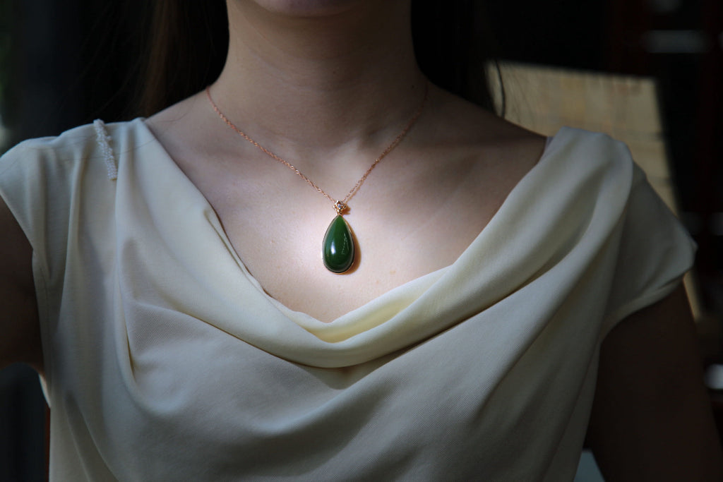 GALET 011 · Spinach Green — nephrite jade pendant, on the model