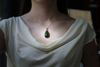 GALET 011 · Spinach Green — nephrite jade pendant, on the model