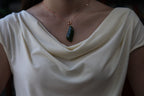 GALET 012 · Spinach Green — nephrite jade pendant, on the model