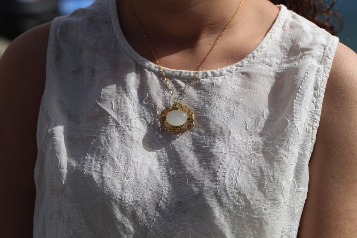 GALET 025 · Suet White — nephrite jade pendant, on the model