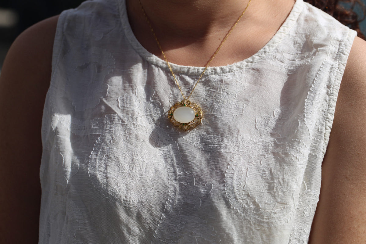 GALET 025 · Suet White — nephrite jade pendant, on the model, close