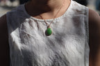 GALET 027 · Willow Green — nephrite jade pendant, on the model