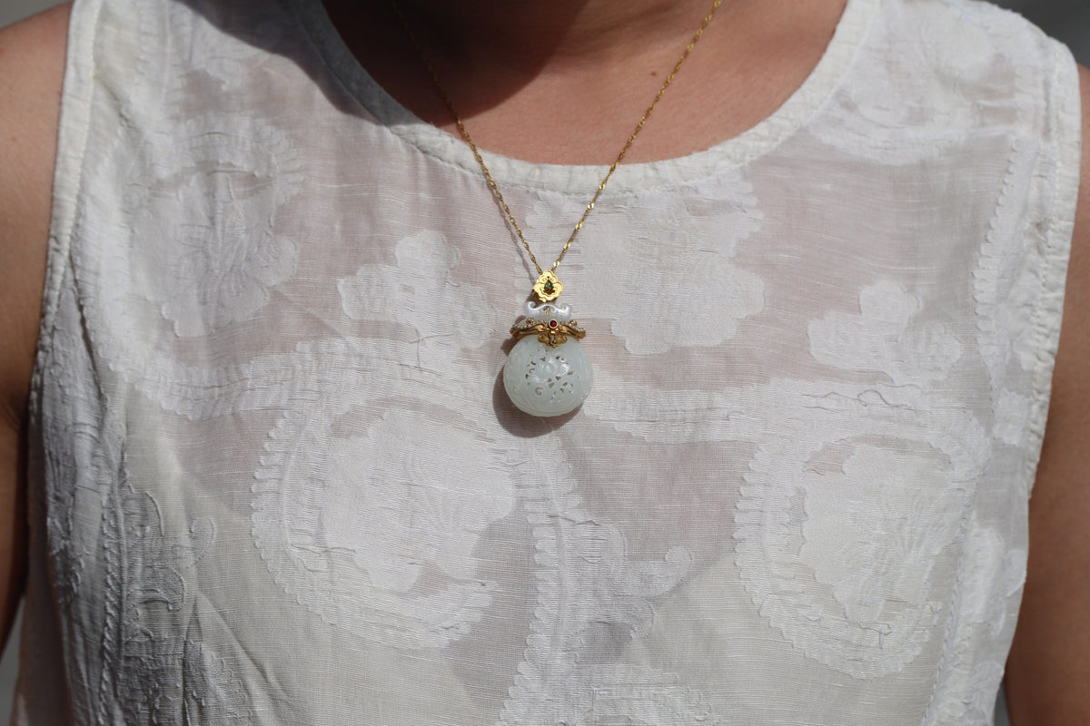 GALET 028 · Suet White — nephrite jade pendant, on the model