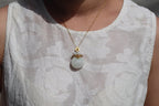 GALET 028 · Suet White — nephrite jade pendant, on the model, close