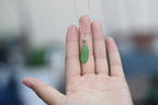 GALET 033 · Willow Green — nephrite jade pendant, in the hand