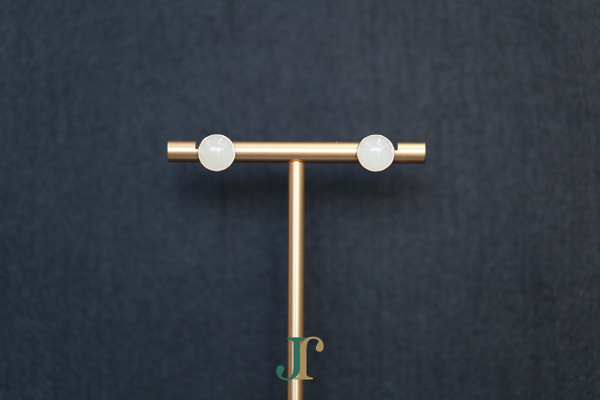 GALET 034 · Suet White — nephrite jade earrings, on a display stand