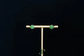 GALET 035 · Willow Green — nephrite jade earrings, on a display stand