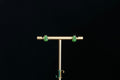 GALET 036 · Willow Green — nephrite jade earrings, on a display stand