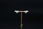GALET 037 · Suet White — nephrite jade earrings, on a display stand