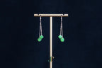 GALET 038 · Willow Green — nephrite jade earrings, on a display stand