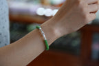 PASTILLE Disc 6×3.5 · Willow Green — nephrite jade pastille bracelet, on the wrist