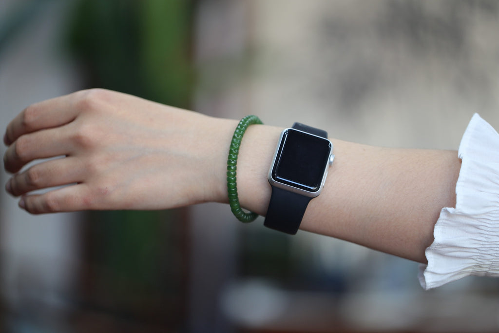 PASTILLE Disc 6×3 · Willow Green 2 — nephrite jade pastille bracelet, on the hand