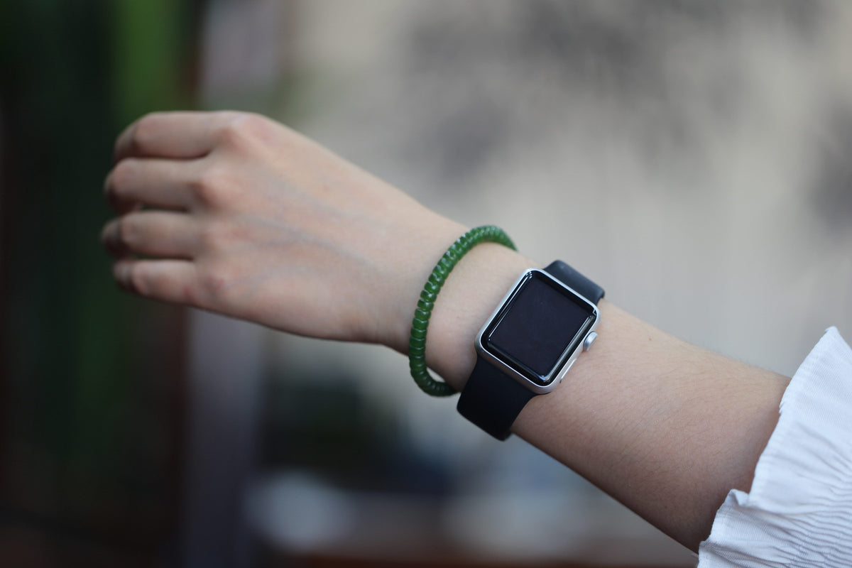PASTILLE Disc 6×3 · Willow Green 2 — nephrite jade pastille bracelet, on the hand, alternate view