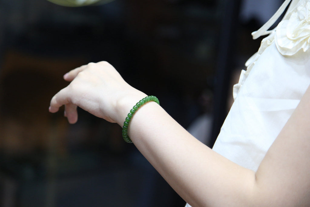 PILLAR Pill 6×5 · Spinach Green — nephrite jade cylinder bracelet, on the hand